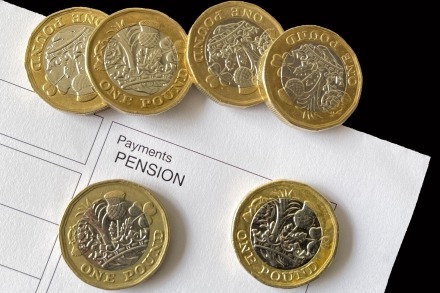 Pound coins on pension document