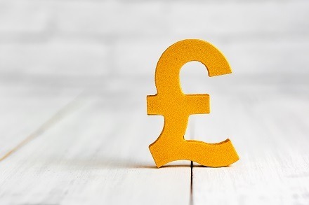 golden pound sign on table, saving pounds with tax planning